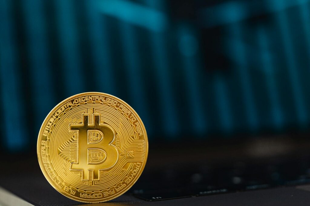 Close-up of a golden Bitcoin coin on a computer keyboard symbolizing digital currency and blockchain technology.