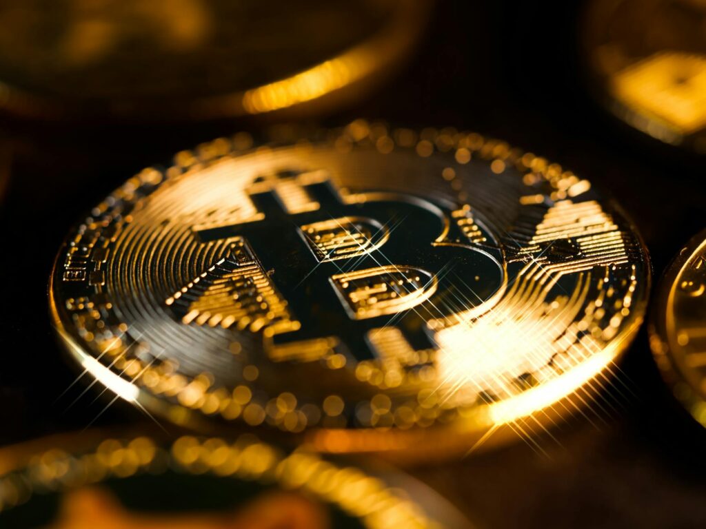 Close-up of golden Bitcoin coins representing digital cryptocurrency and finance.
