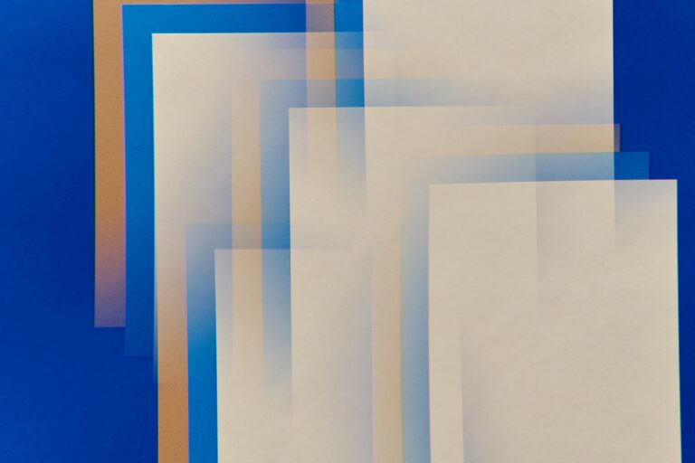 Abstract geometric composition with layered rectangles on a vibrant blue background, showcasing modern art style.
