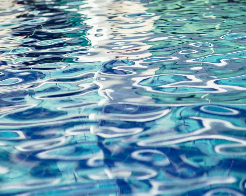 Close-up of turquoise rippled water surface in a tranquil swimming pool.