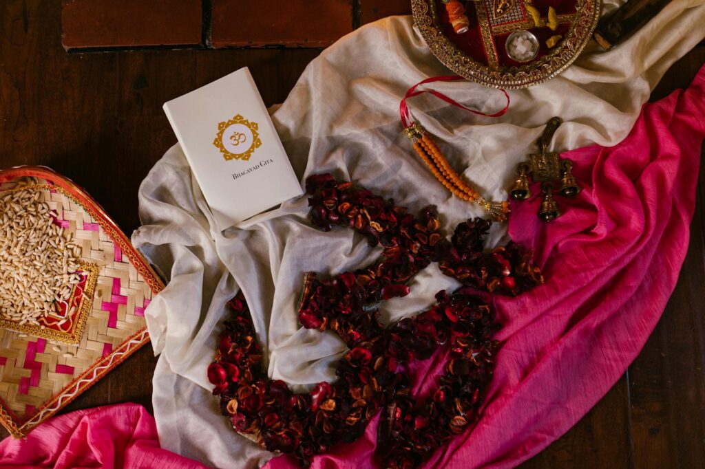 A vibrant still life featuring traditional Hindu items for Diwali celebration on colorful fabric.