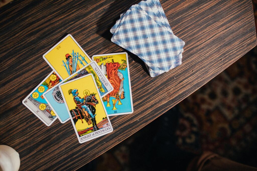Intriguing tarot card spread on a textured wooden table, exuding mystical energy.